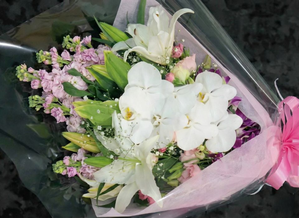 家族葬のアートが越谷市で葬儀用に束ねた白百合と胡蝶蘭の供花ブーケ